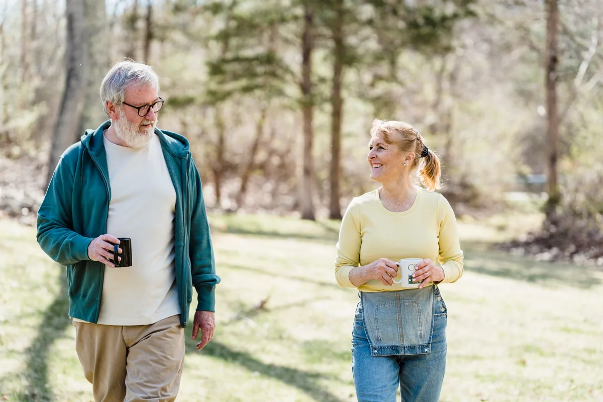 Two adults walking outdoors in a park