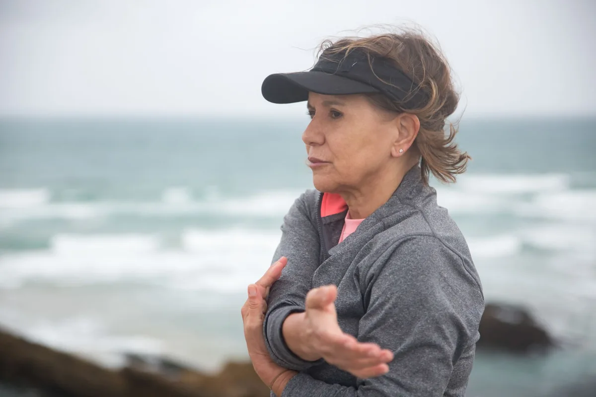 Woman exercising beside the sea
