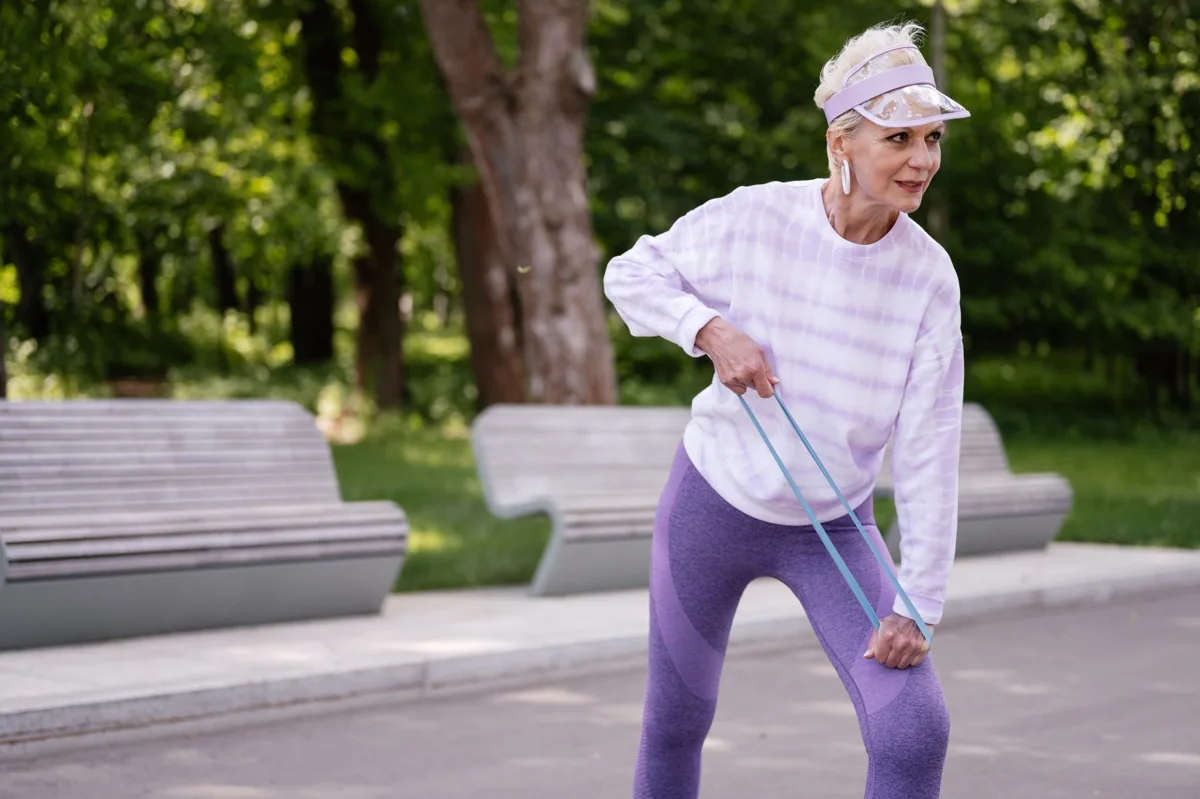 Woman using a resistance band outdoors