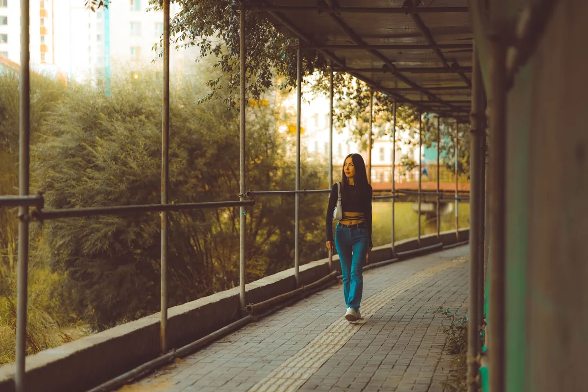 Woman walking along a covered outdoor path