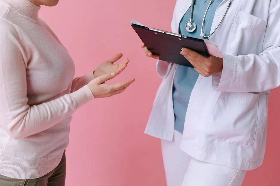 Doctor and patient reviewing a clipboard during a consultation