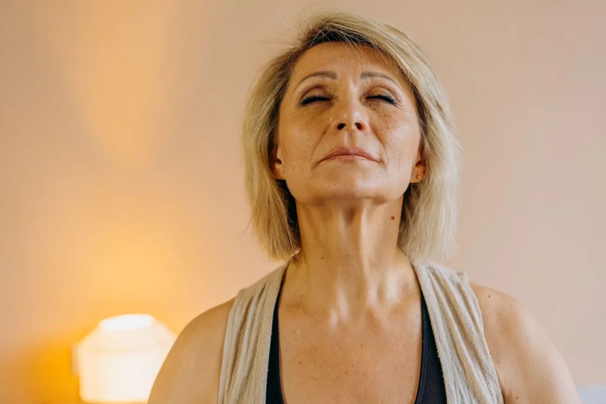 Woman sitting with her eyes closed