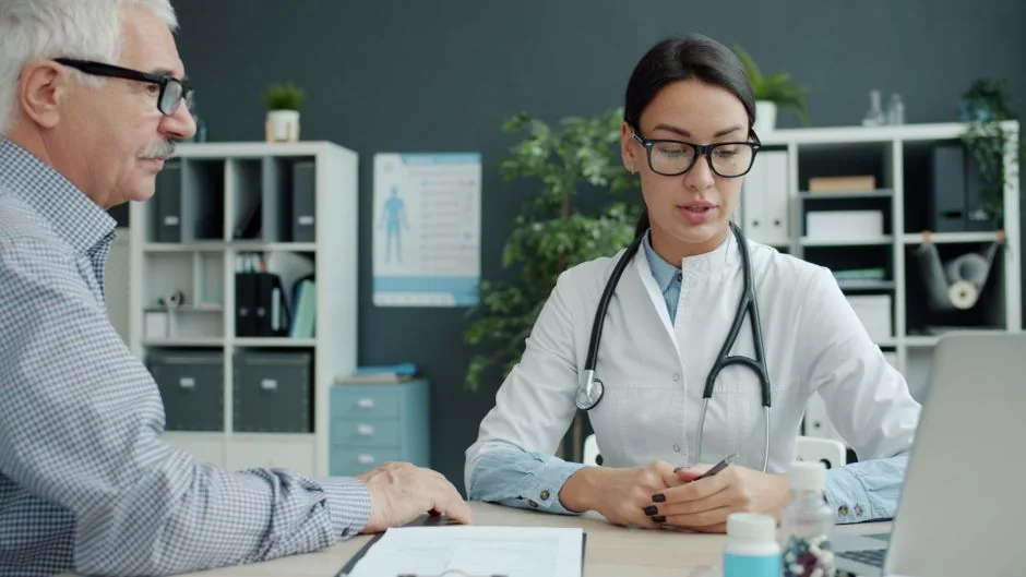 Clinician discussing medical information with an adult patient