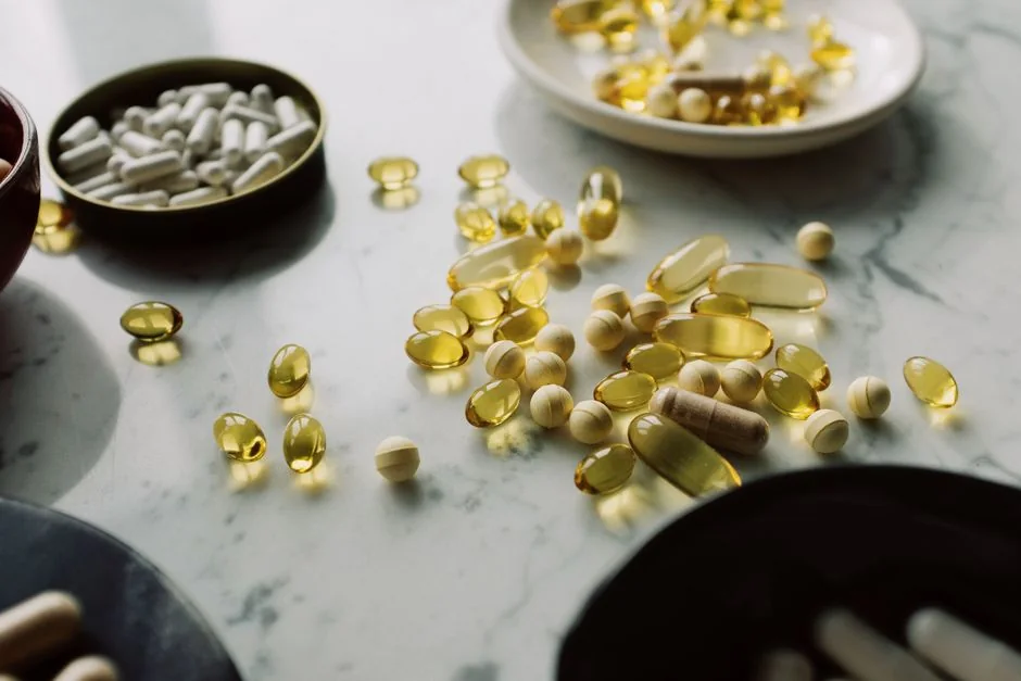 Assorted tablets and capsules on a marble surface